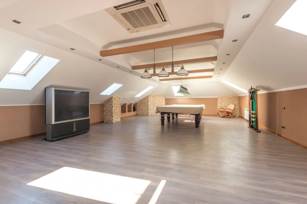 Bright attic space featuring a sleek pool table and skylights, perfect for leisure.