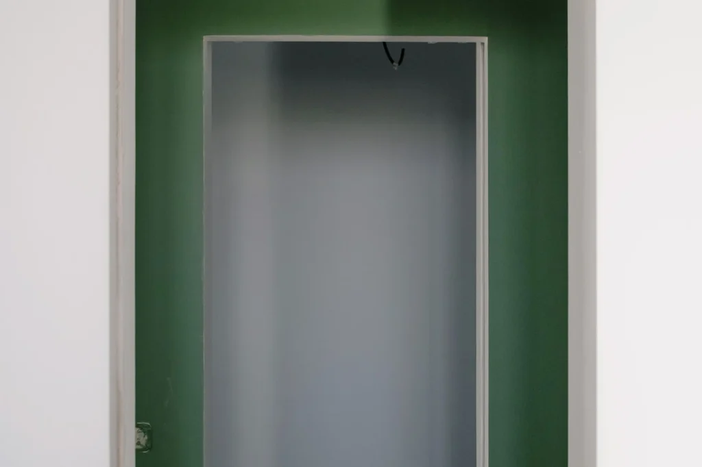 Empty doorway in new light apartment with colorful walls during repair work in daytime